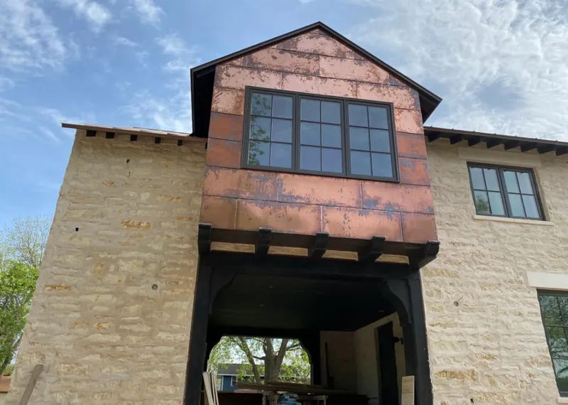 Copper metal panel facade on a stone building for Skylight Installation in Encinitas