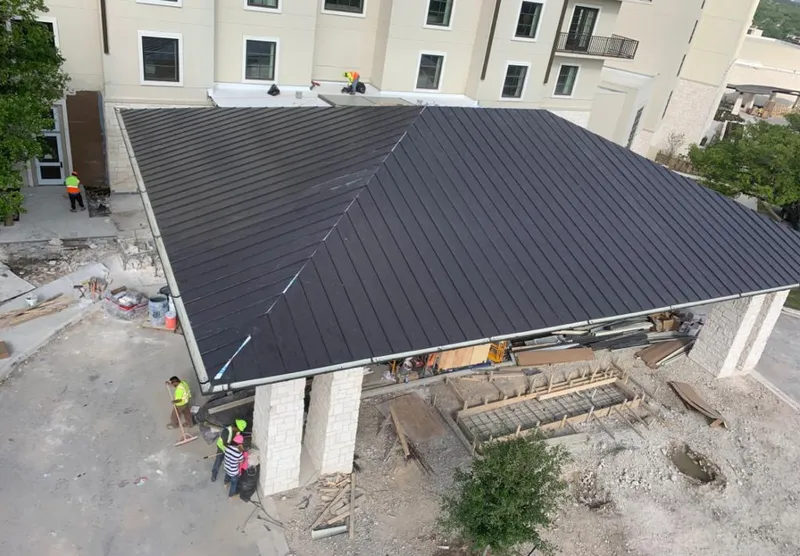 Metal roofing installation team working on a commercial building in Encinitas